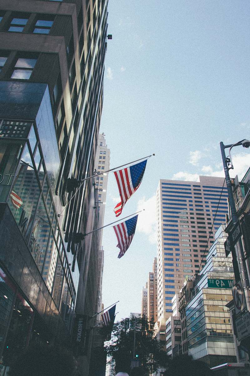 building two USA flag mounted on building architecture